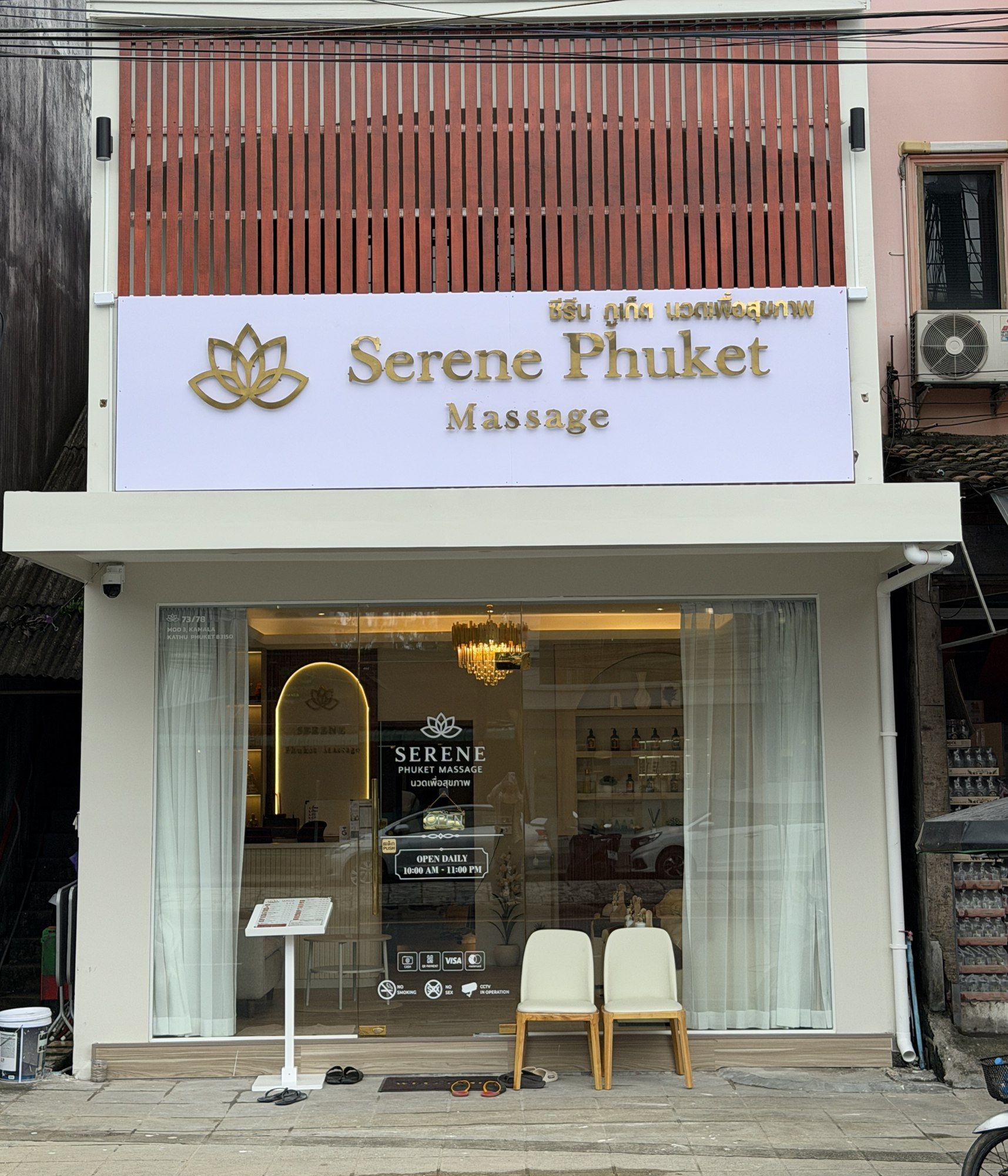 Salon front with wooden slats and the gold lotus sign